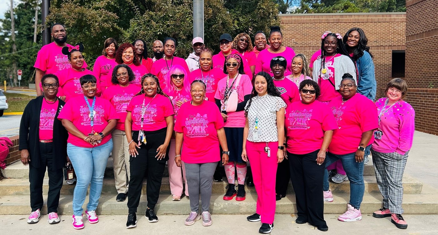 A photo of teachers wearing pink for breast cancer.